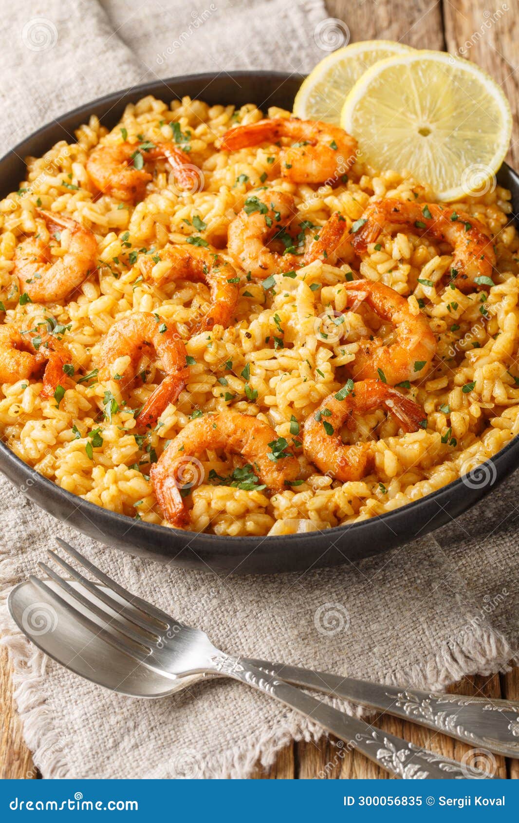 italian risotto ai gamberi or shrimp risotto a closeup on the plate. vertical