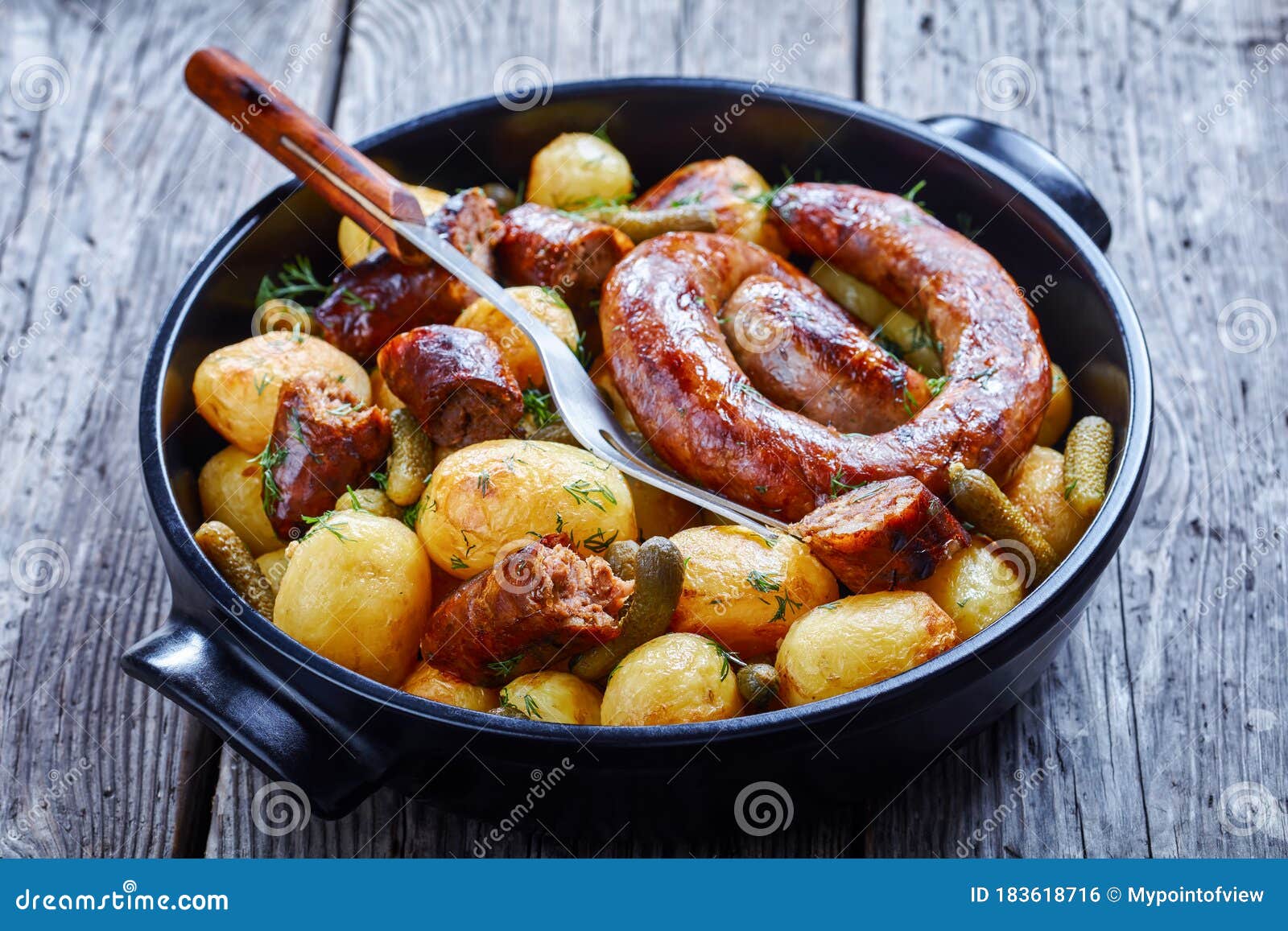 italian sausage roasted with new potato on a dish