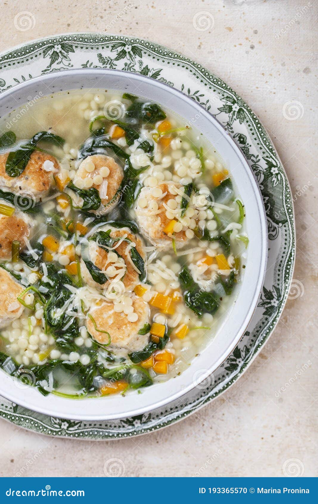 Italian Wedding Soup with Meatballs and Ptitim Paste Stock Photo
