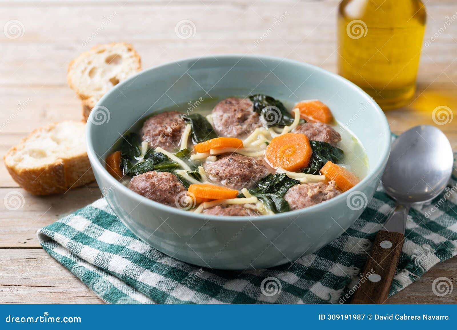 Italian Wedding Soup with Meatballs and Spinach on Wooden Table Stock