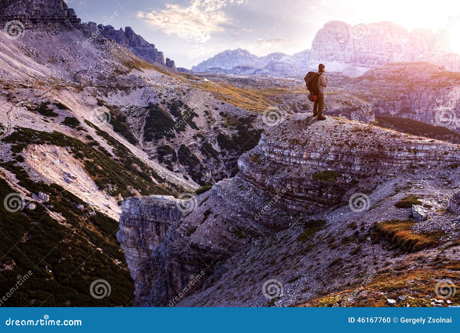 italy, dolomites - male hiker standing on the barren rocks