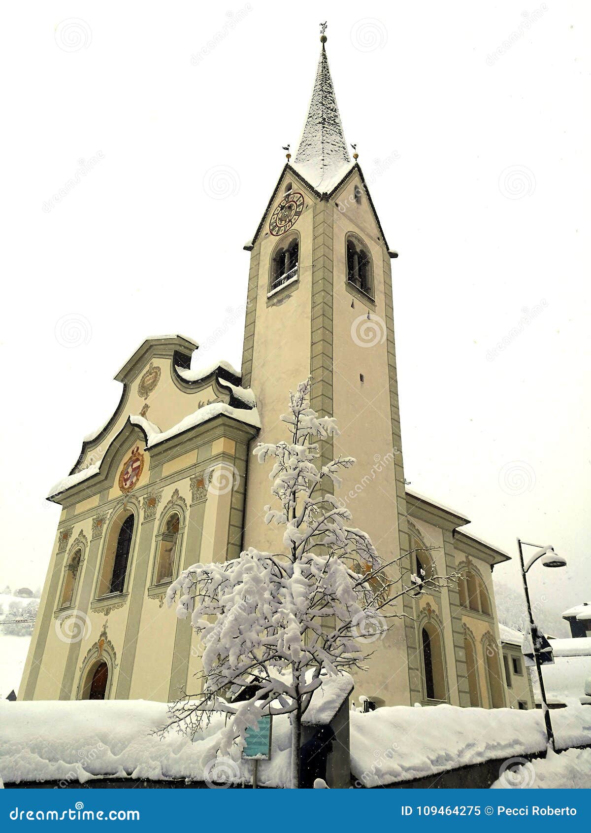 italy, trentino alto adige, bolzano, san vigilio di marebbe, view of the church of the town during a winter day and during a snowf