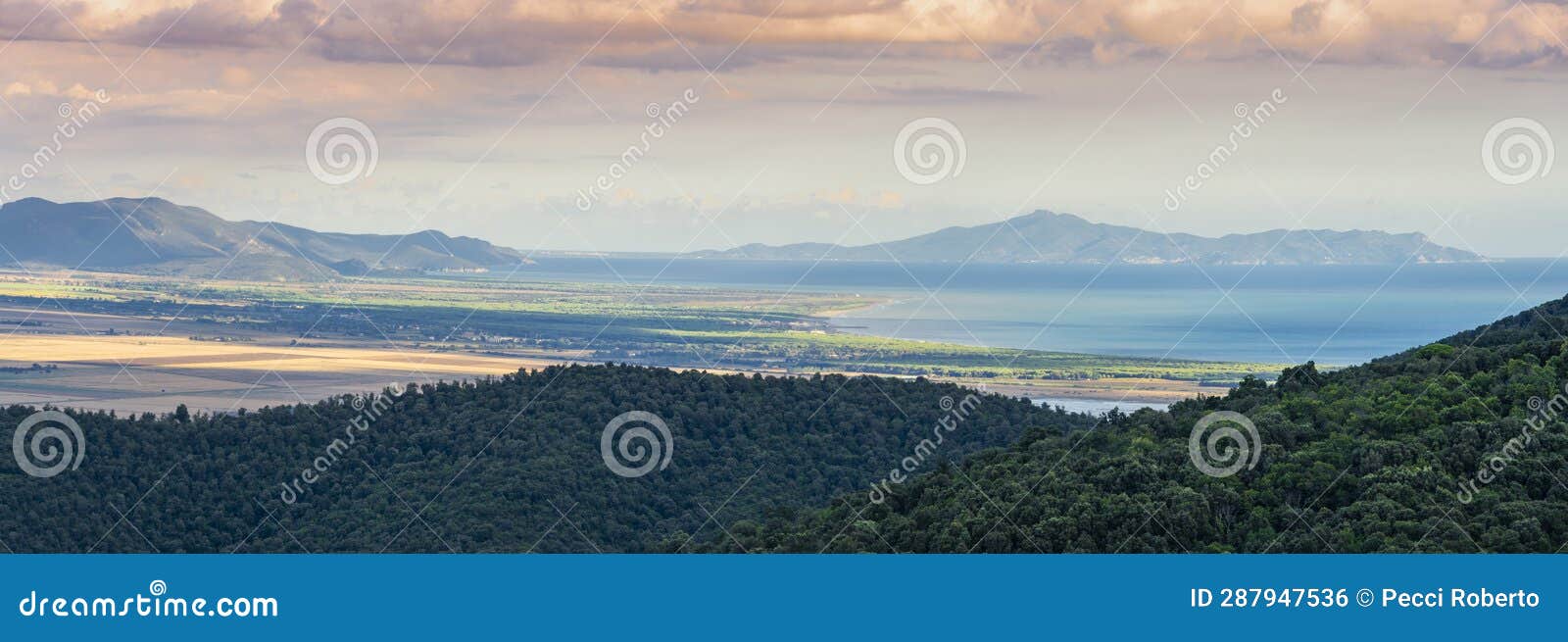 italy, tuscany, tirli, panoramic view at the sunset of the meremmana plain, the coastline up to the uccellina mountains and the
