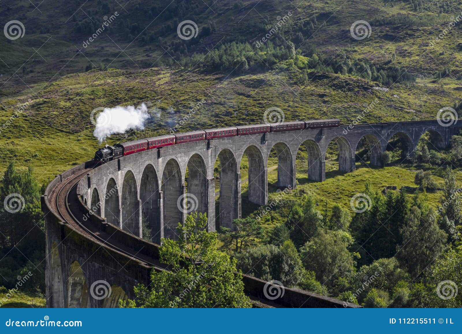 Jacobite Steam Train On Glenfinnan Viaduct Approaching Highlands