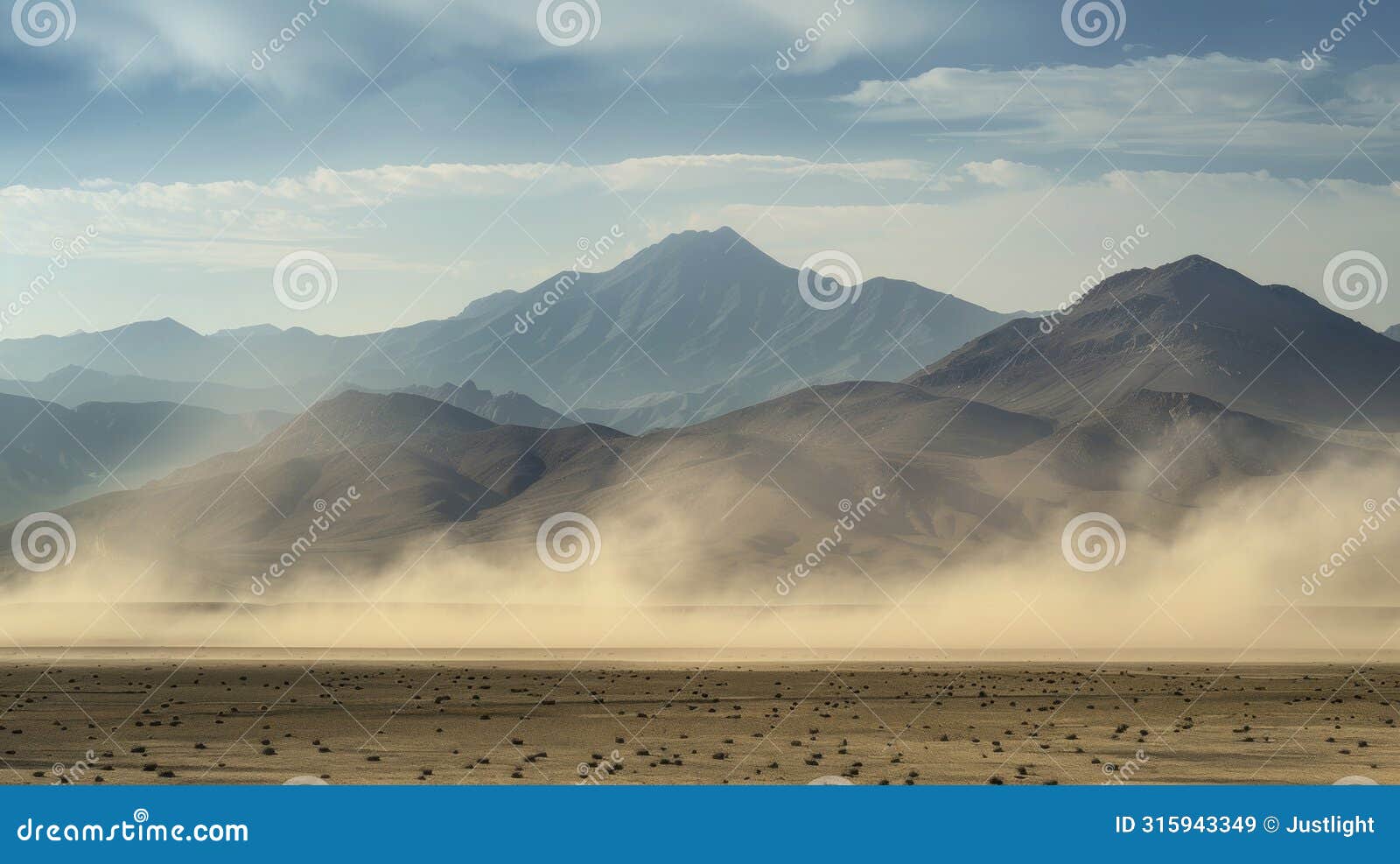 a jagged mountain range looms in the distance shrouded in a thick layer of swirling dust and sand.