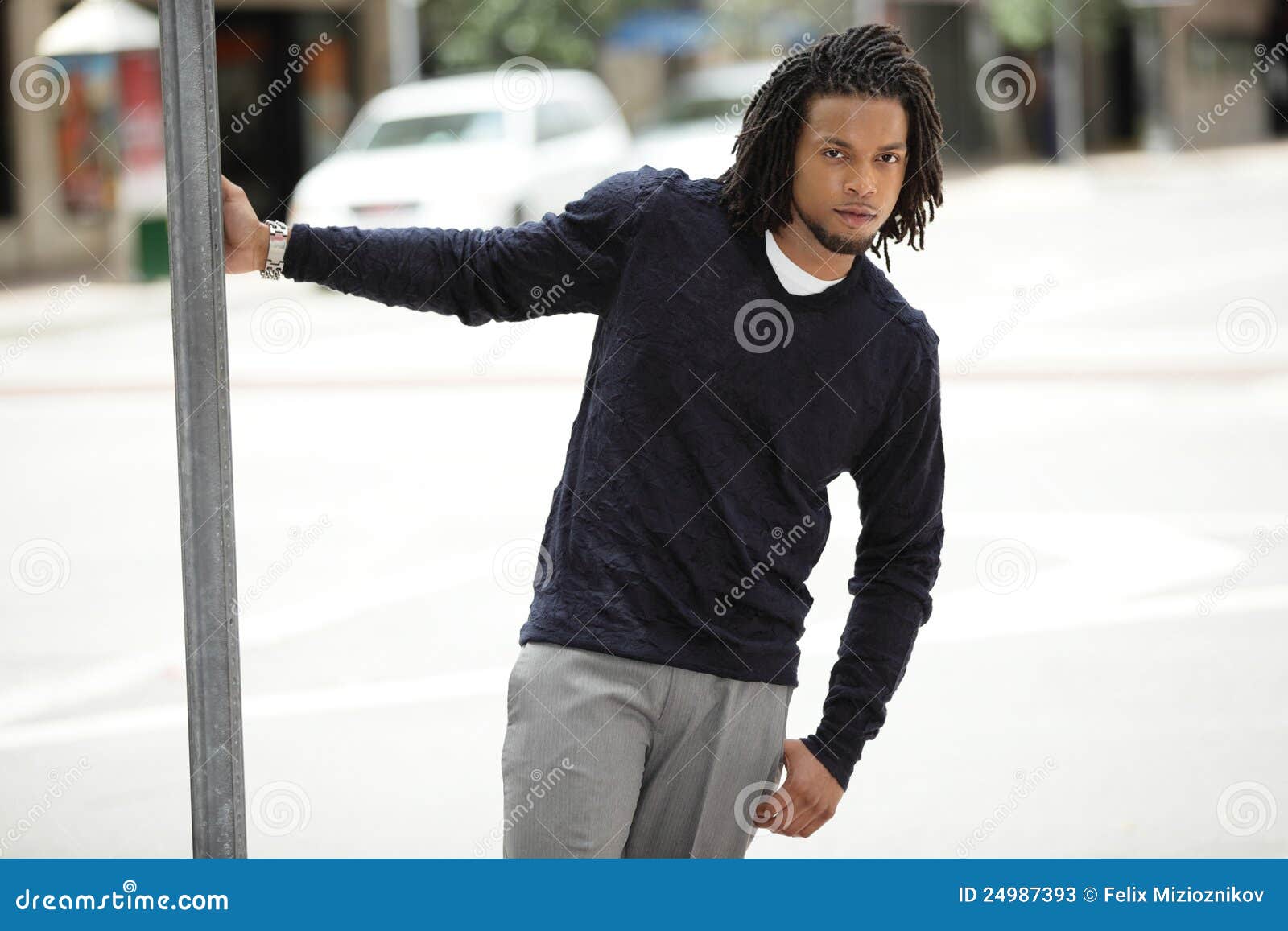 Jamaican Man Hanging From A Pole Stock Photos - Image 