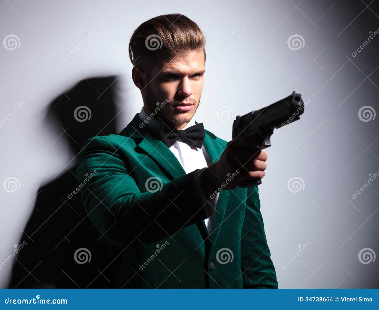 james bond wannabe young assasin pointing his big pistol