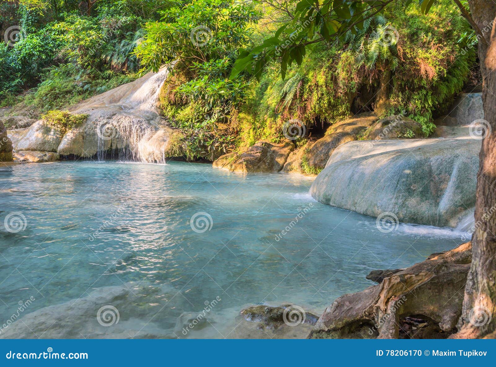 jangle landscape with flowing turquoise water of erawan