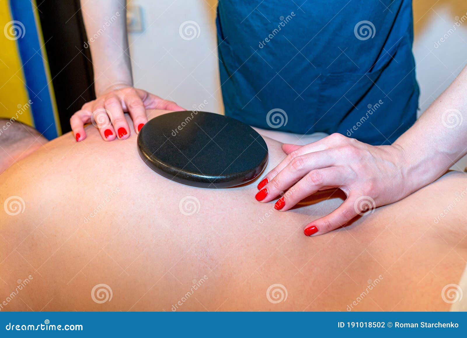Japanese Back Massage With Warm Black Stones In The Massage Parlo
