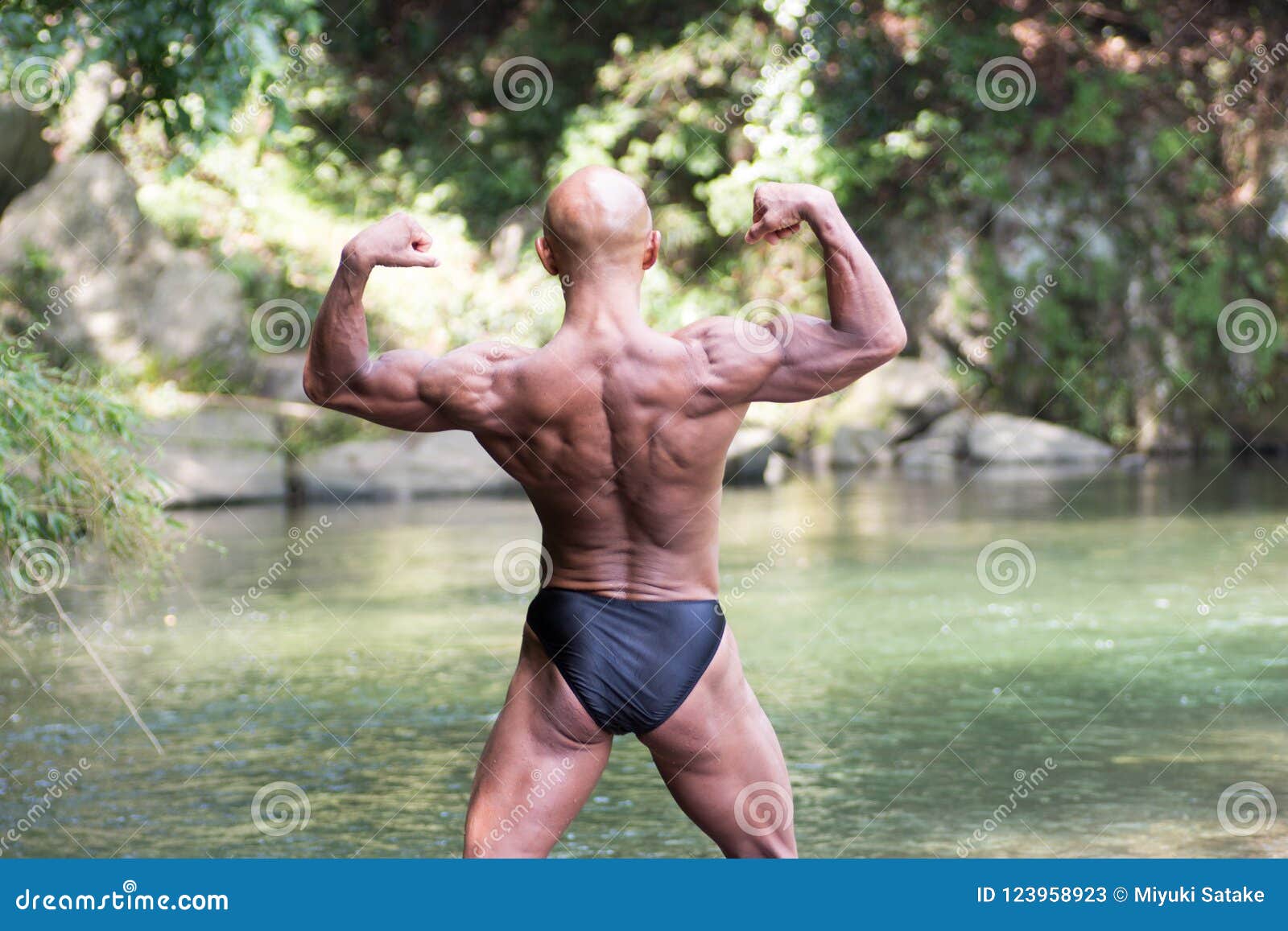 Japanese Bald Head Bodybuilder Posing the Back Double Biceps at