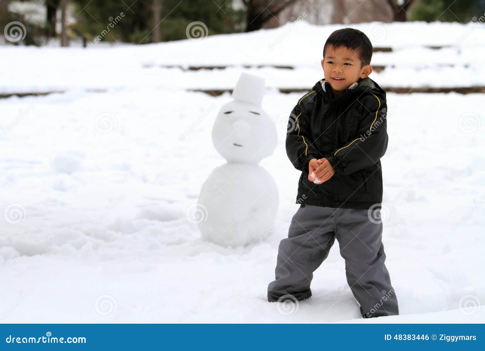 Japanese boy having snowball fight and snowman (4 years old)