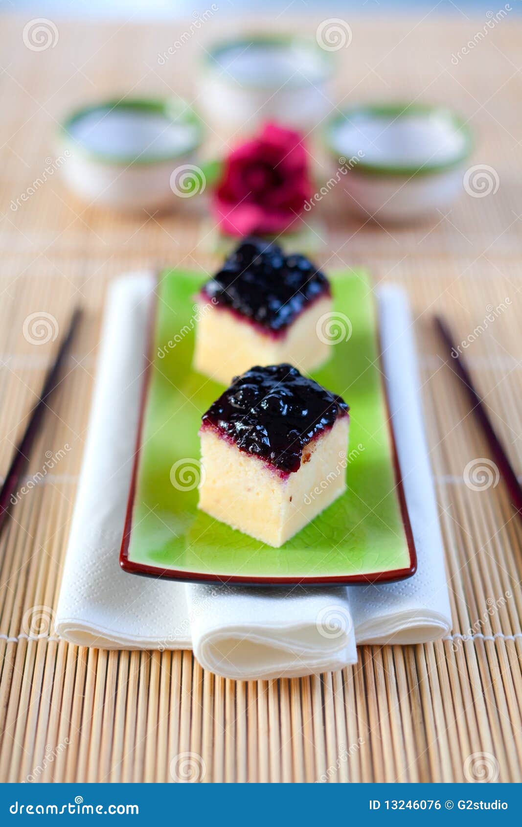 Japanese cheesecake treats served on an asian plate with chop sticks. Shallow depth of field on the first cheesecake treat.