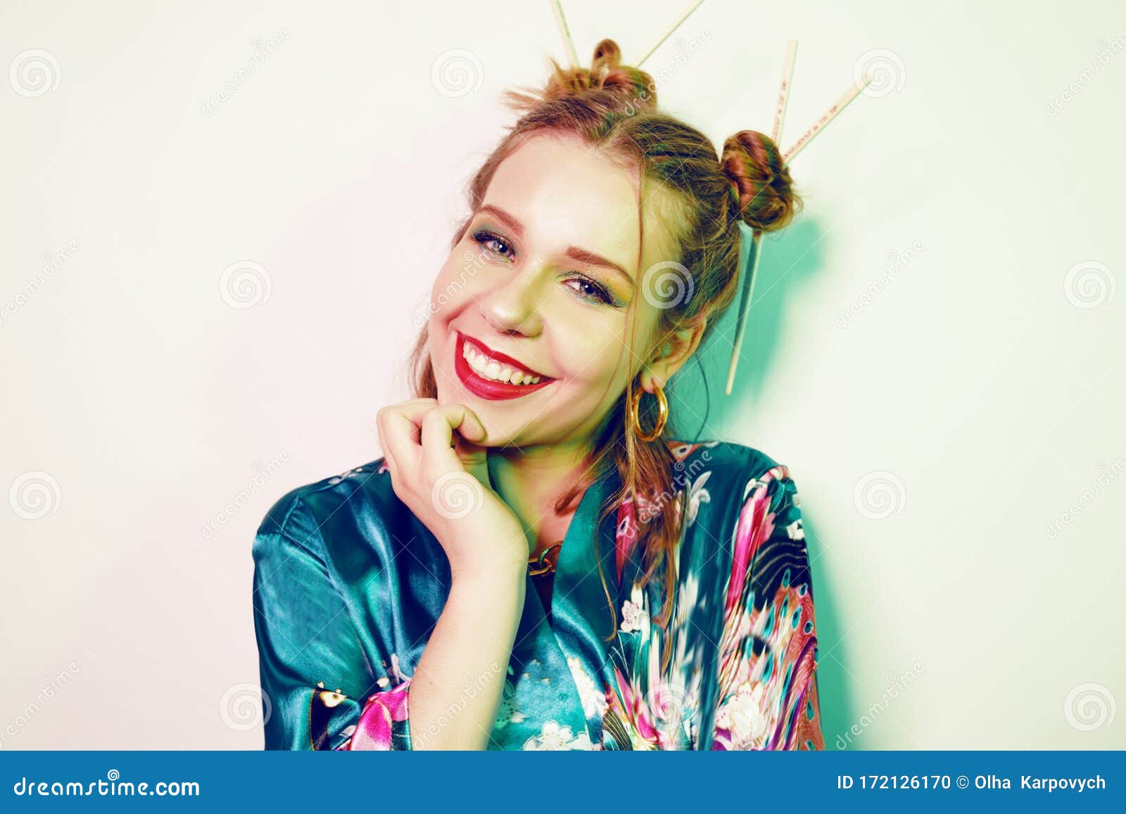 Japanese  Chinese  Asian Style Girl With Chopsticks In Her Hair Girl  With An Interesting Hairstyle On A Green Background In A Japanese Chinese  Bathrobe The Girl Is Looking At The