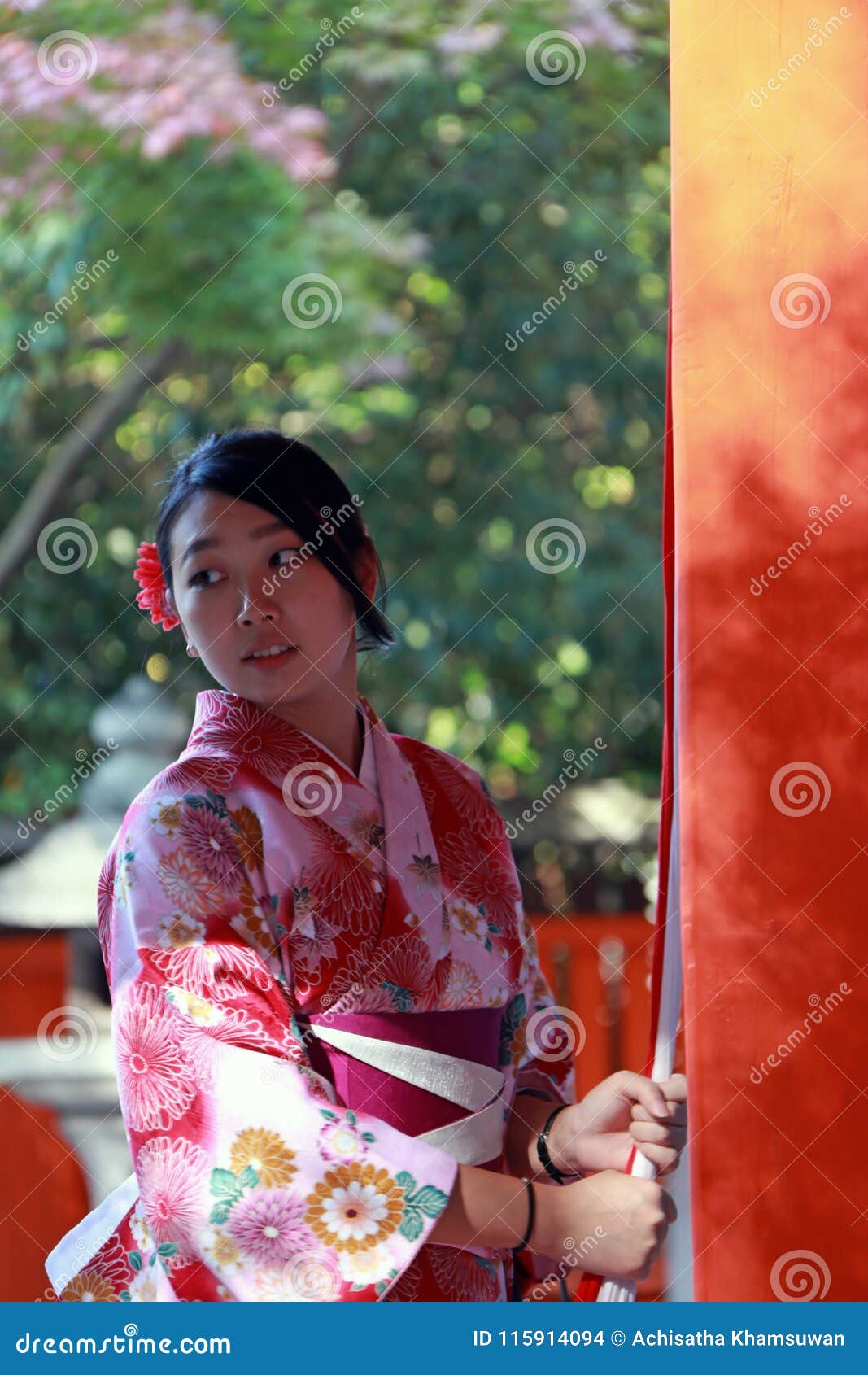 Japanese Girl In Kimono Dress Stand And Catch Fabric Rope To Ringing The Bell For Bless At