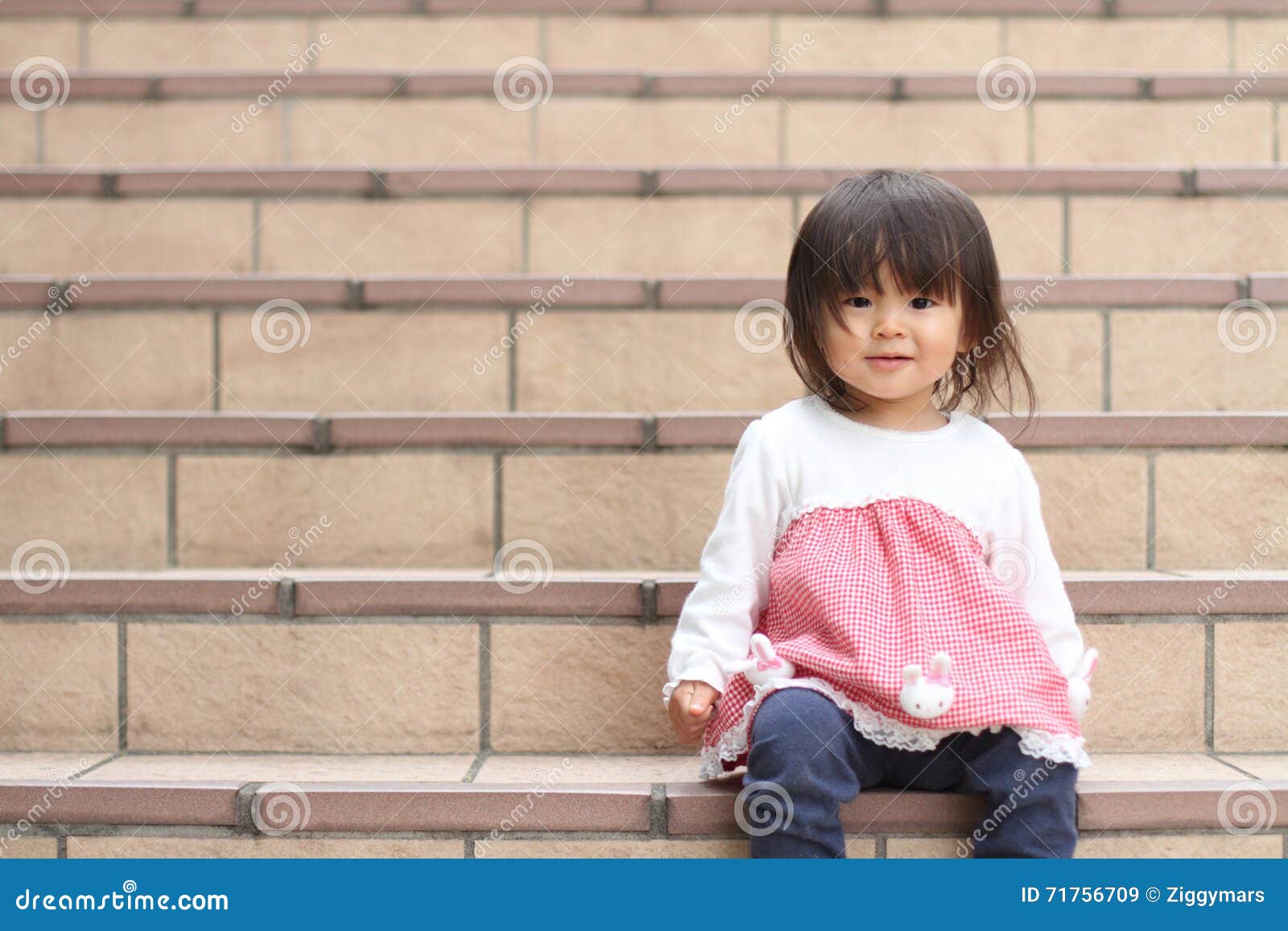 Cute japanese girl is walking up the stairs in her dress