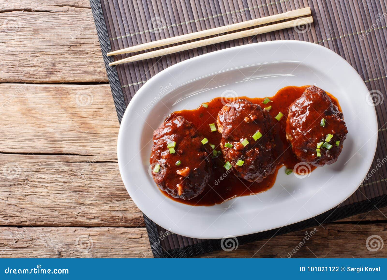 japanese hambagu steak with sauce close-up on a white plate. horizontal top view