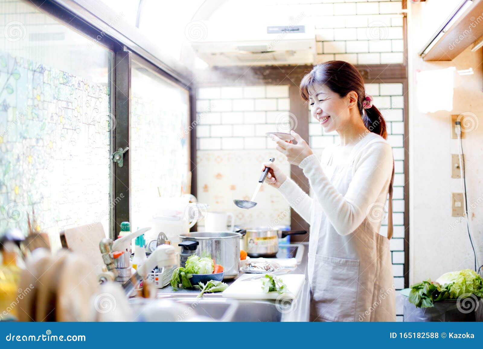 Japanese Housewife Tasting Cooking Stock Photo