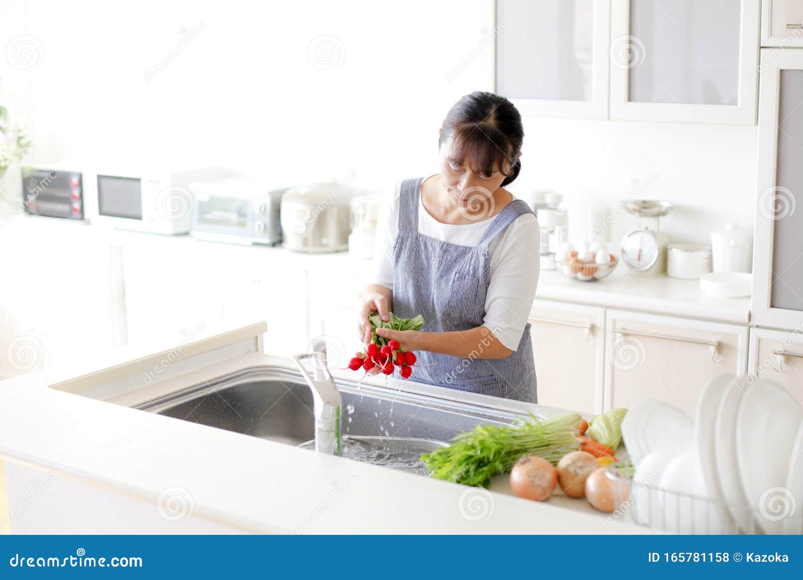 Japanese Housewife Washing Vegetables Stock Photo