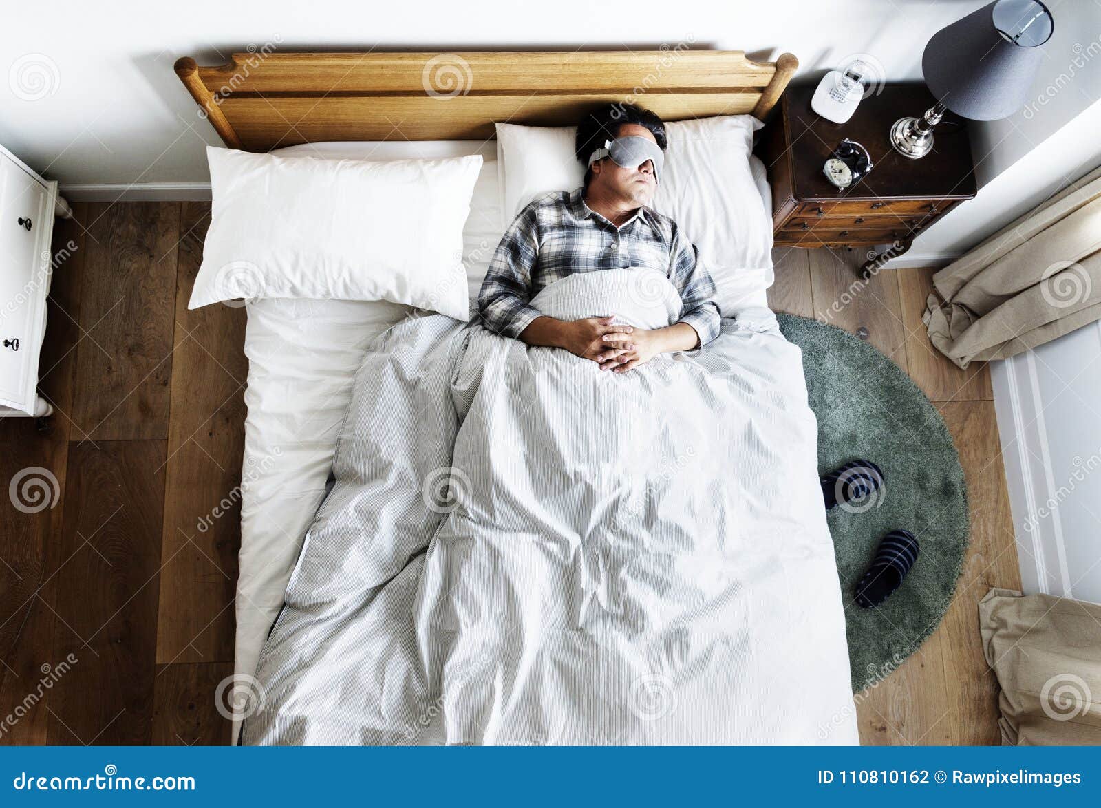 japanese man sleeping on bed with eye mask