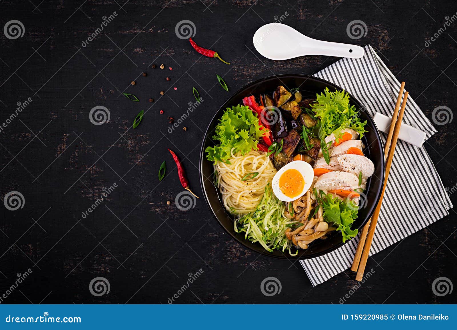 japanese ramen soup with chicken, egg, shimeji mushrooms and eggplants
