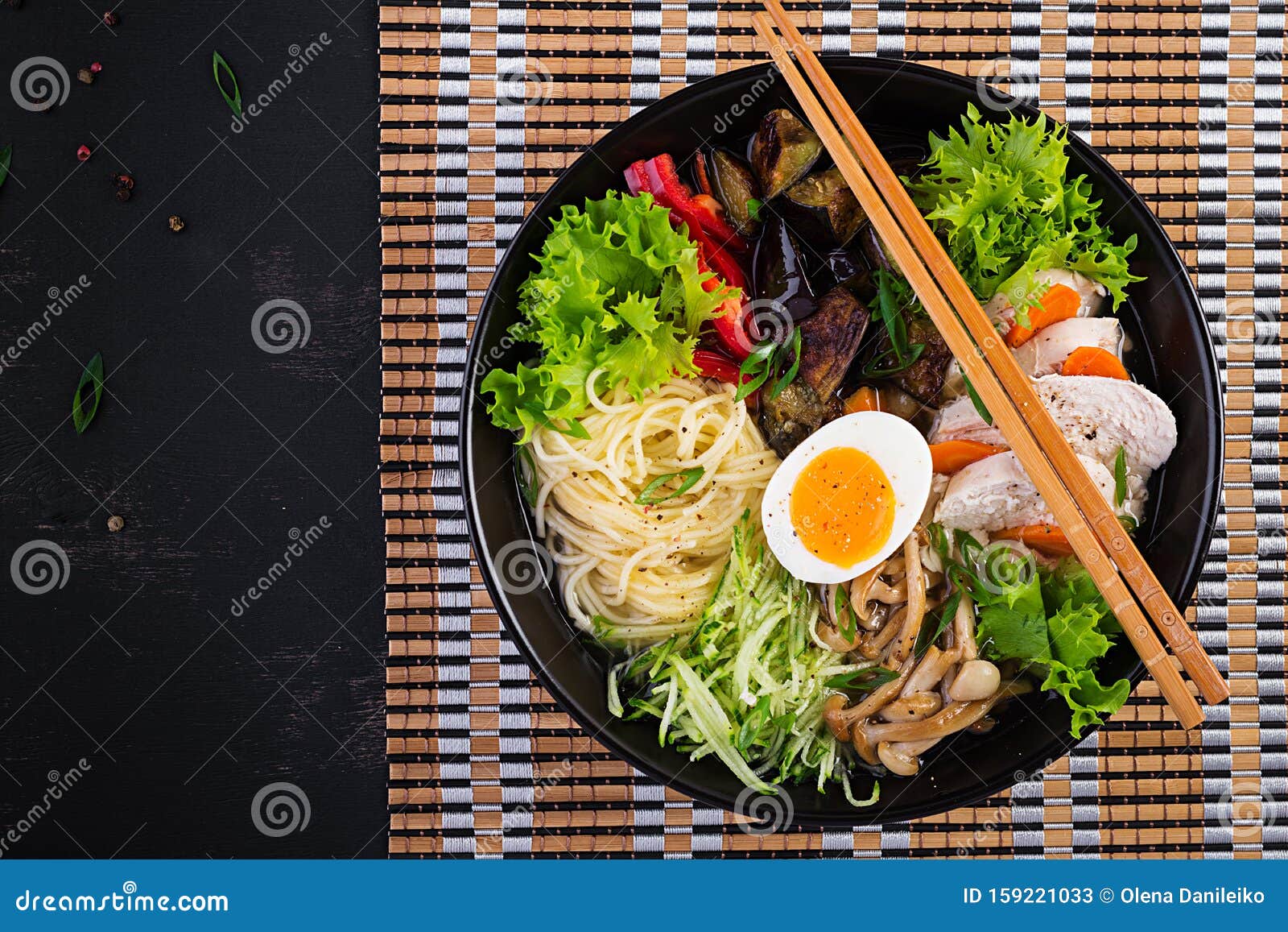 japanese ramen soup with chicken, egg, shimeji mushrooms and eggplants