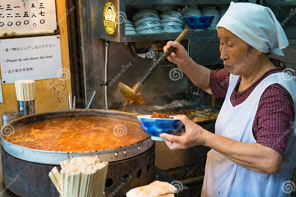 Japanese Street Food Vendor Preparing Food in Tokyo Editorial
