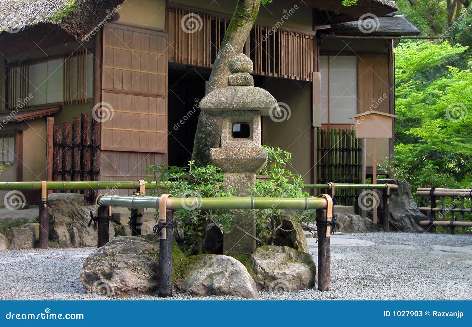Very traditional Japanese tea house with stone lantern in front of it Very traditional Japanese tea house with stone lantern in front of it