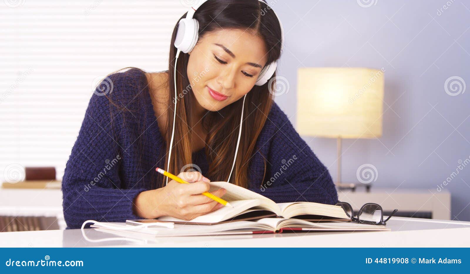 Japanese Woman Listening To Music While Doing Homework ...