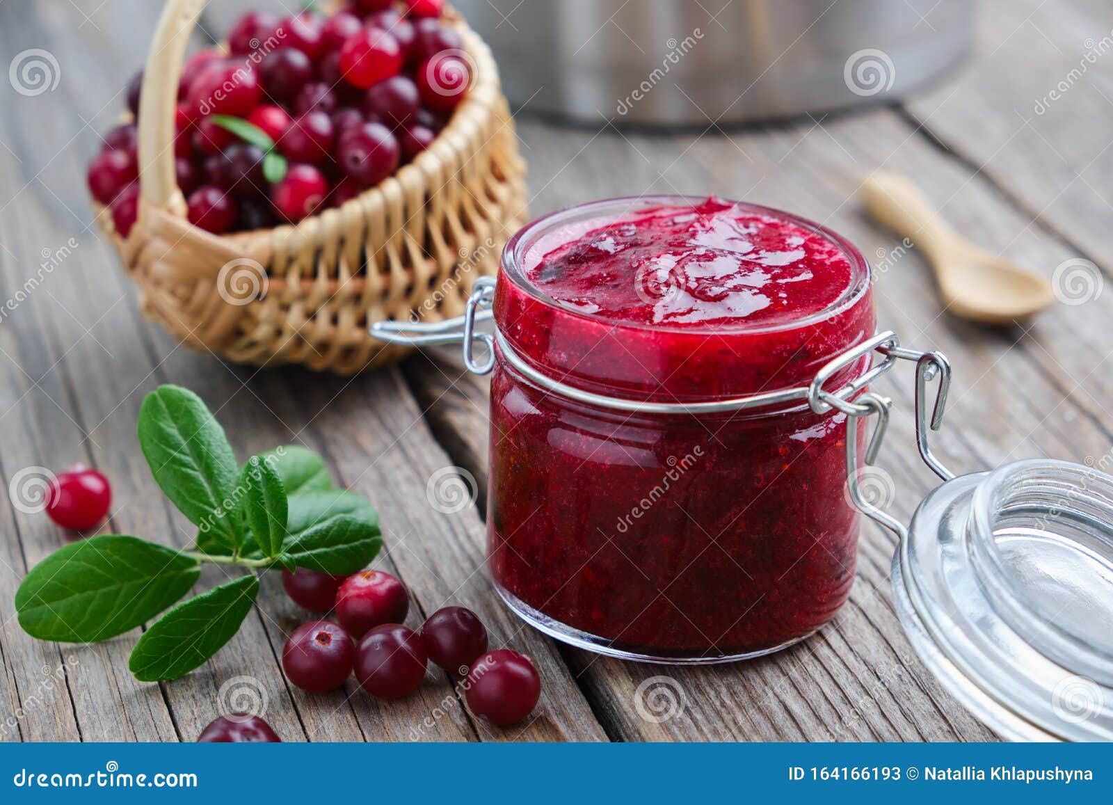 Jar of Crushed Cranberries for Sauce or Jam and Basket of Bog Berries