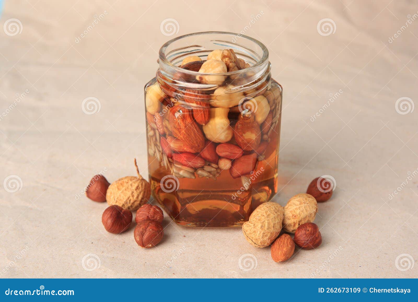 Jar of nuts in honey isolated on white background Stock Photo