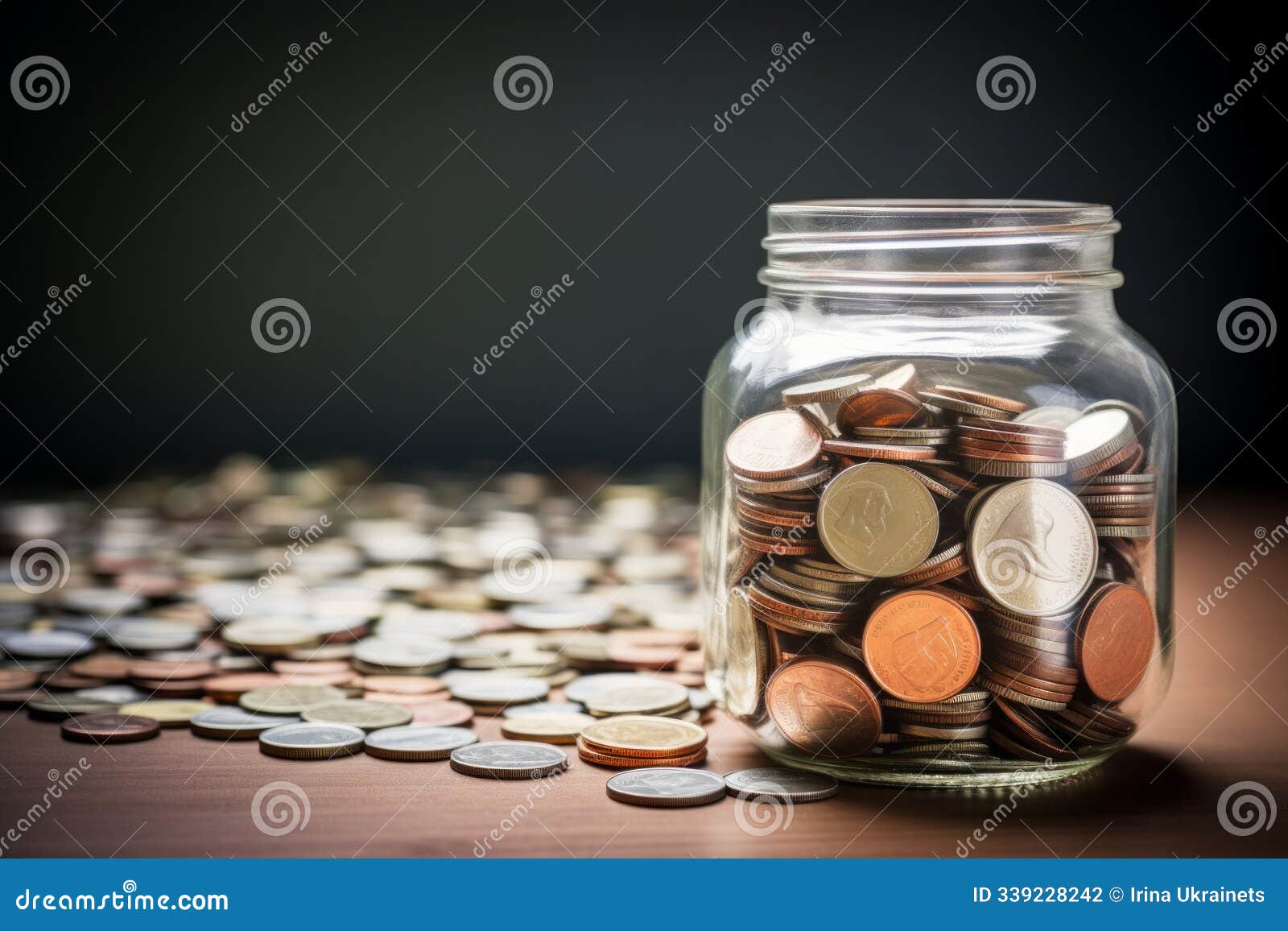 a jar filled with coins sits on a wooden table. coins are scattered around it, creating an interesting arrangement. this