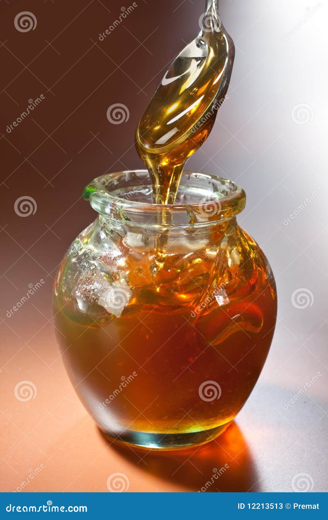 Jar of honey and a spoon stock image. Image of studio 12213513