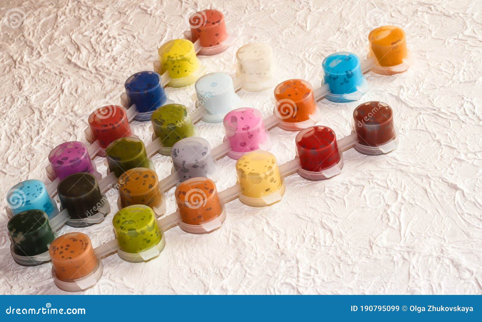 Jars With Acrylic Paint On A Light Crumpled Background Stock Photo