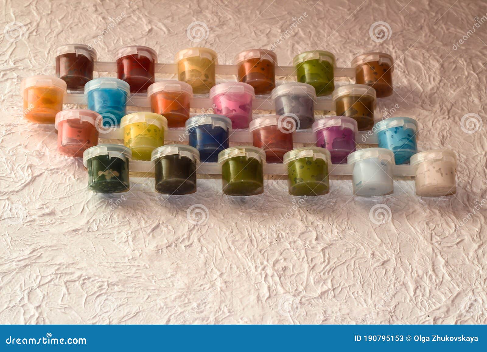 Jars With Acrylic Paint On A Light Crumpled Background Stock Image