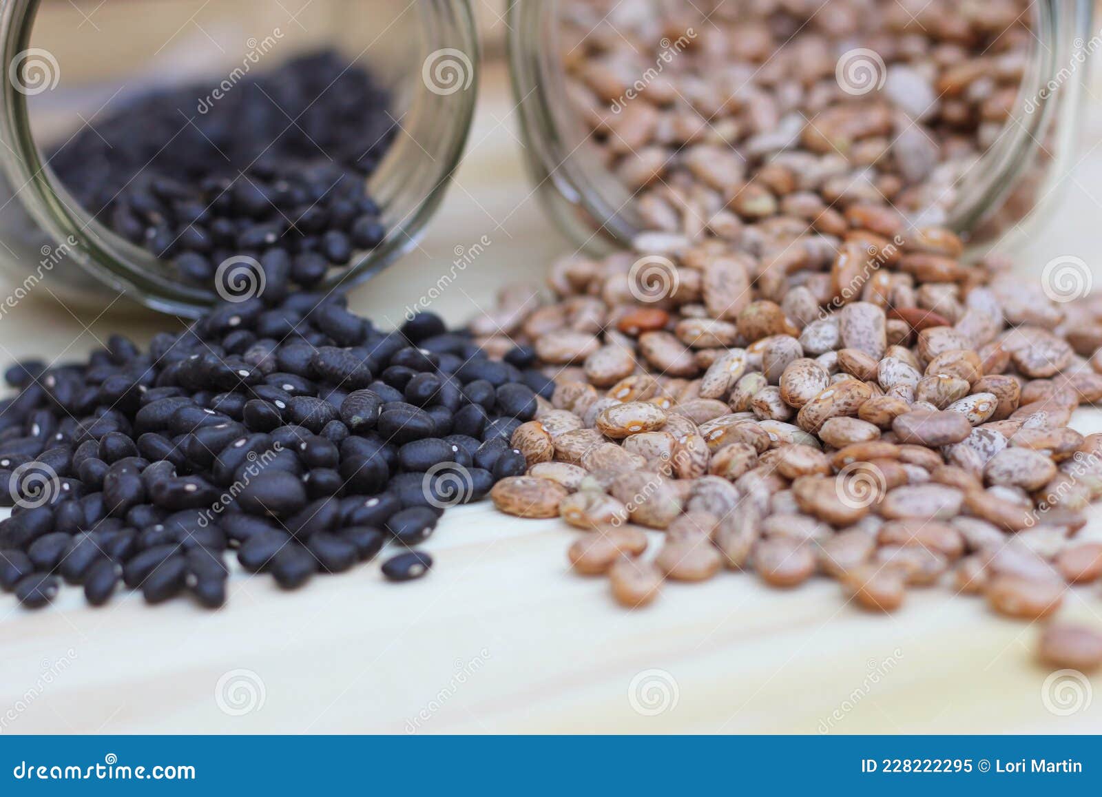 Jars of Black Beans and Pinto Beans Spilled on Kitchen Counter Stock