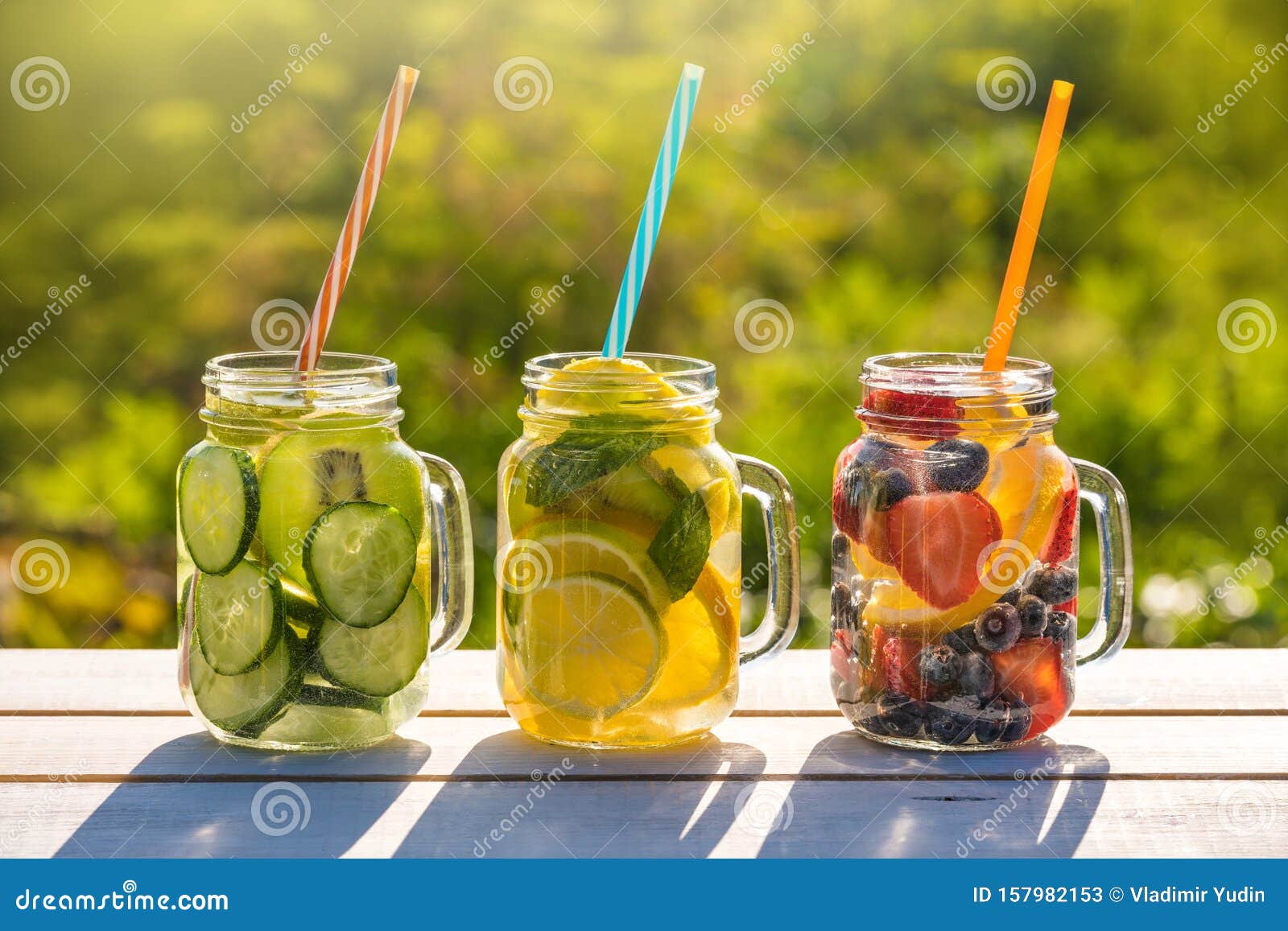 mason jars of infused water with fruits