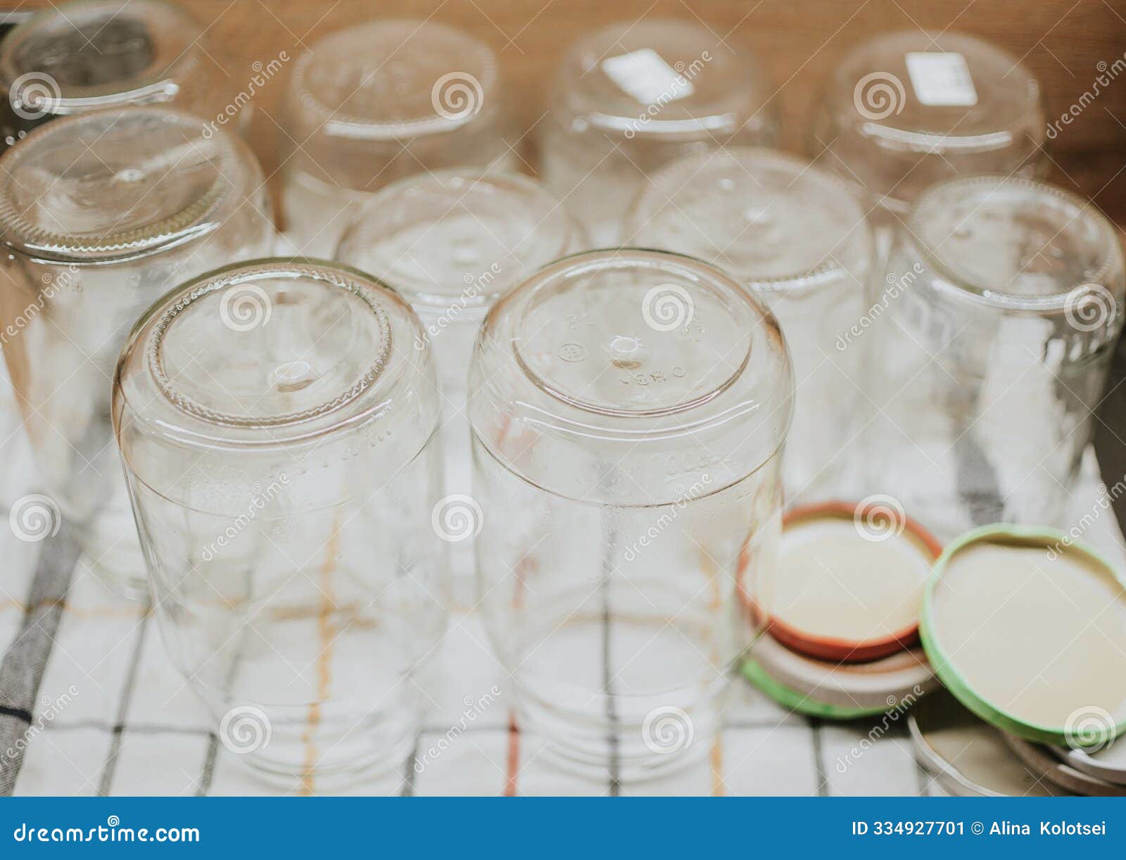 jars with lids for seaming with tomatoes and cucumbers for the winter standing on a towel