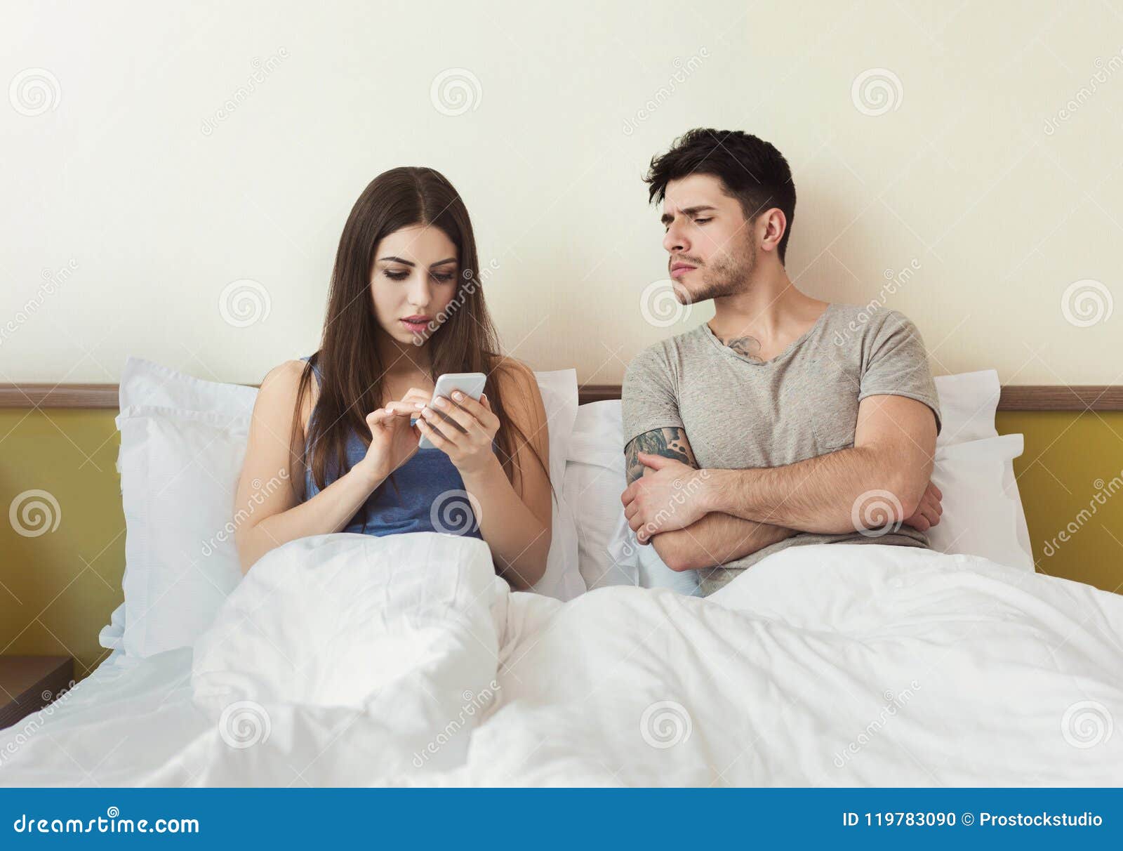 Jealous Husband Watching His Wife Using Mobile Phone Royalty-Fre image
