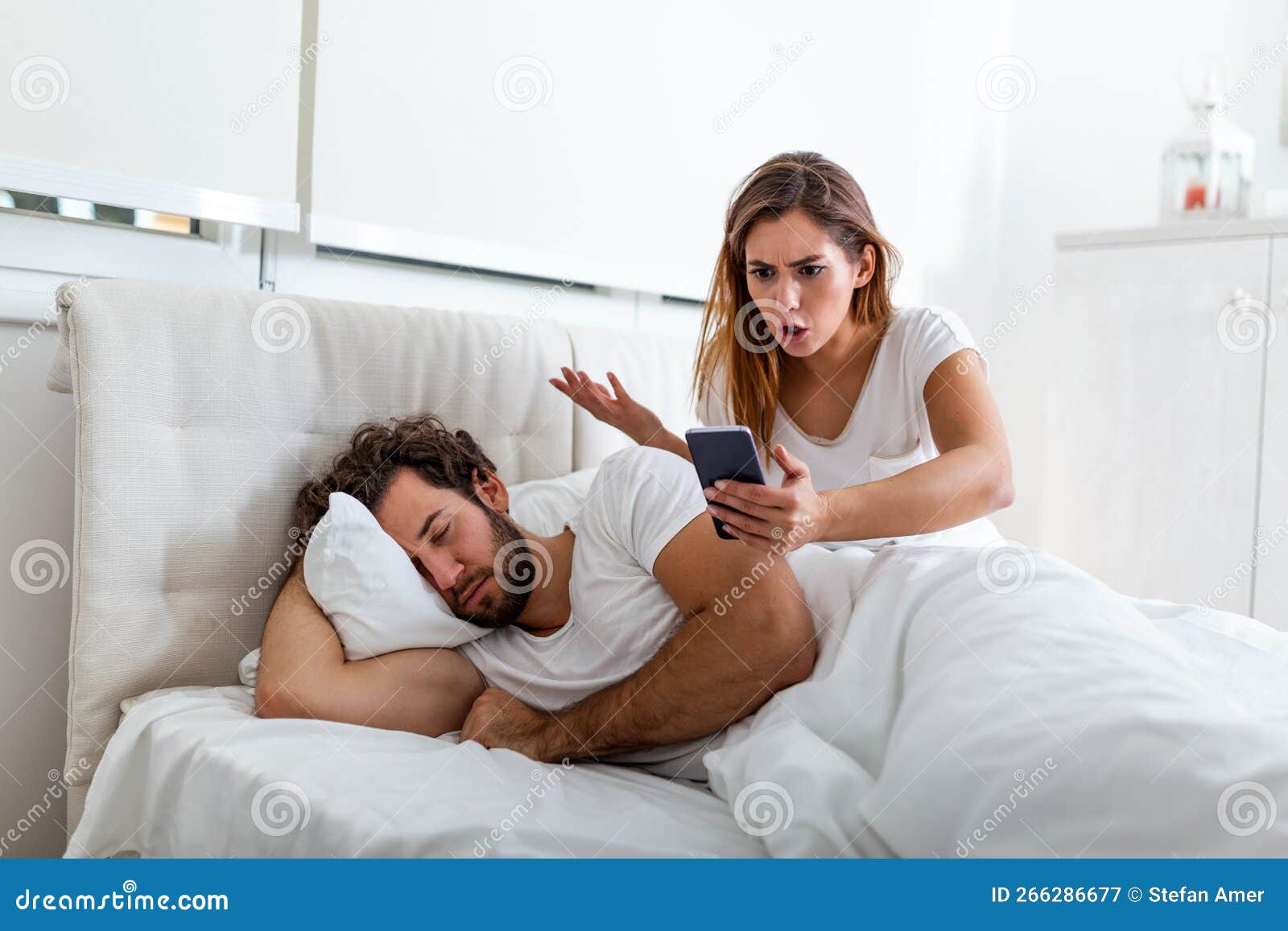 Jealous Wife Spying The Phone Of Her Partner While He Is Sleeping In A Bed At Home Shocked