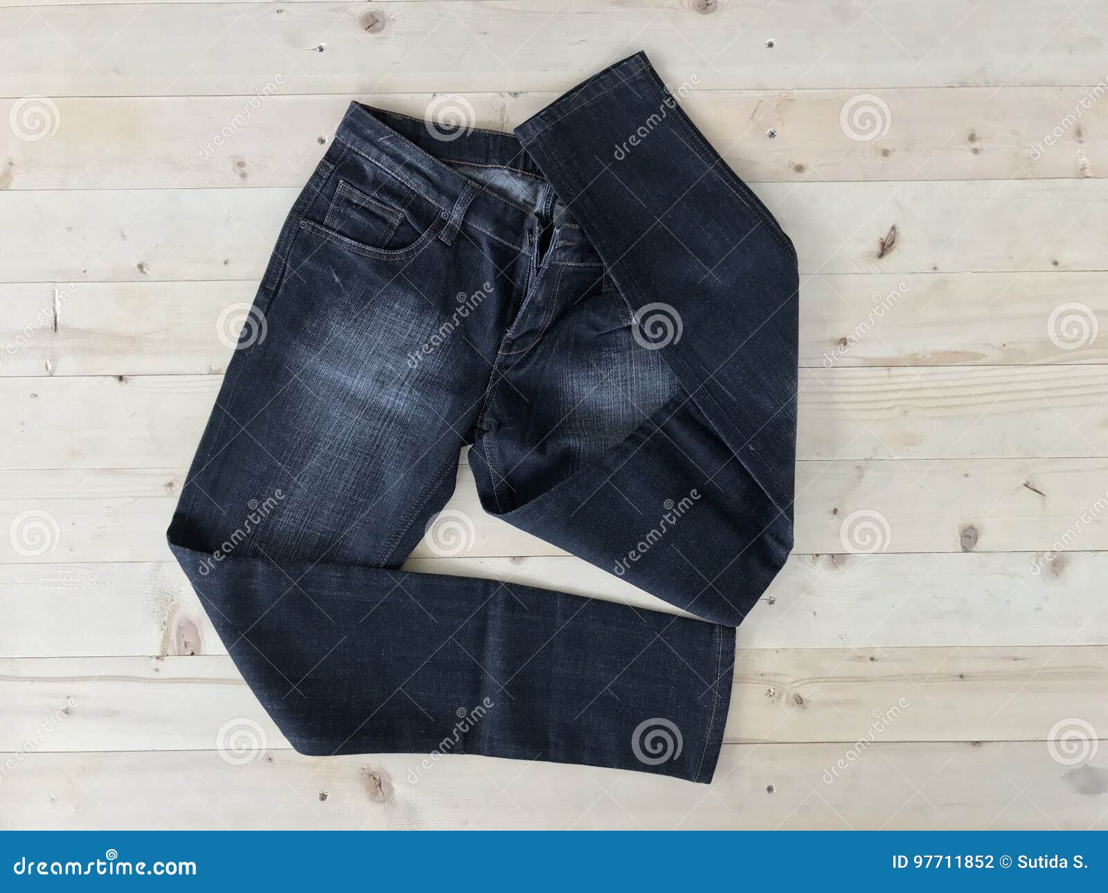 Jean pants on wood floor stock photo. Image of denim - 97711852