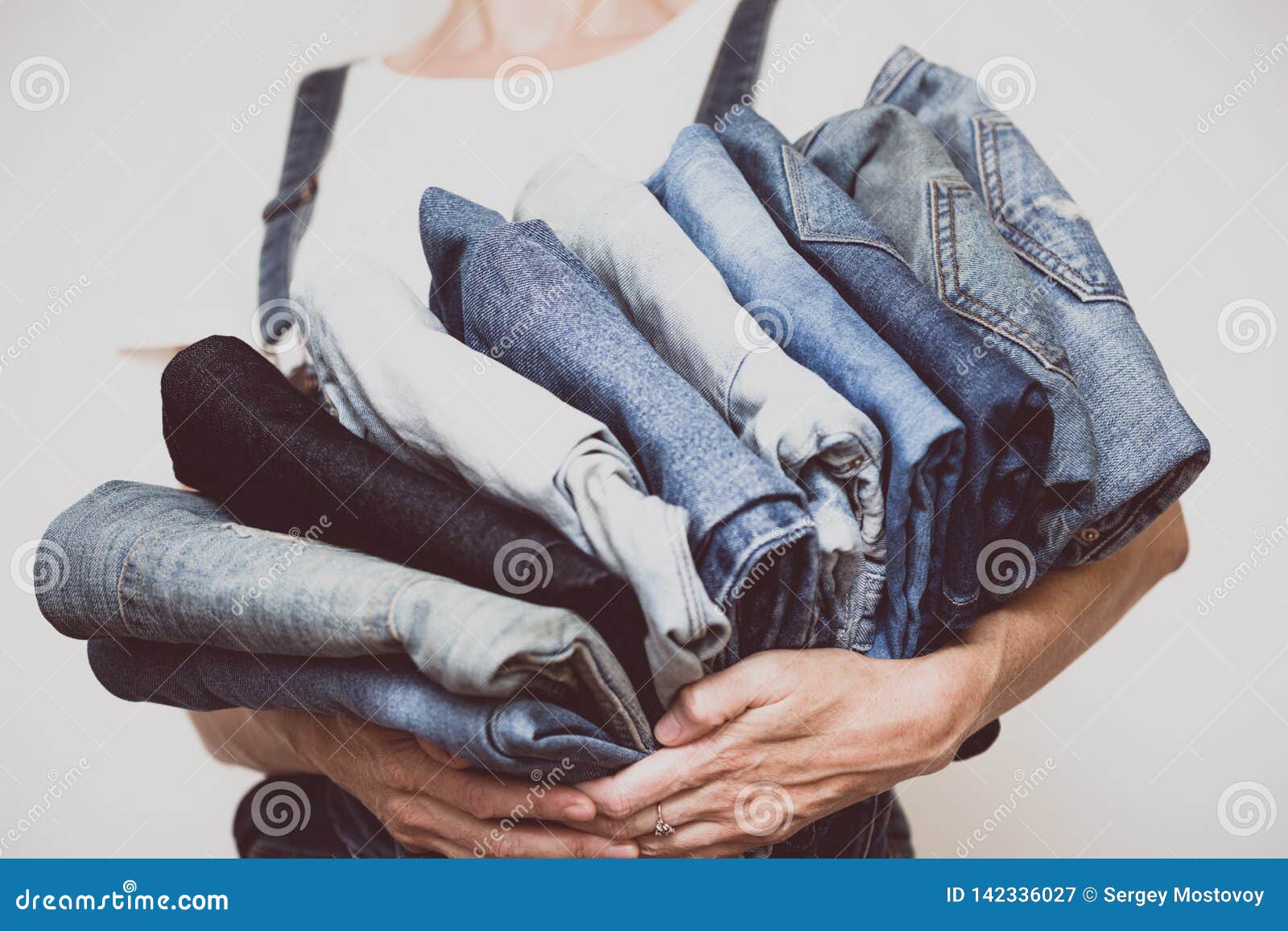 Jeans in her hands stock image. Image of object, clothes - 142336027