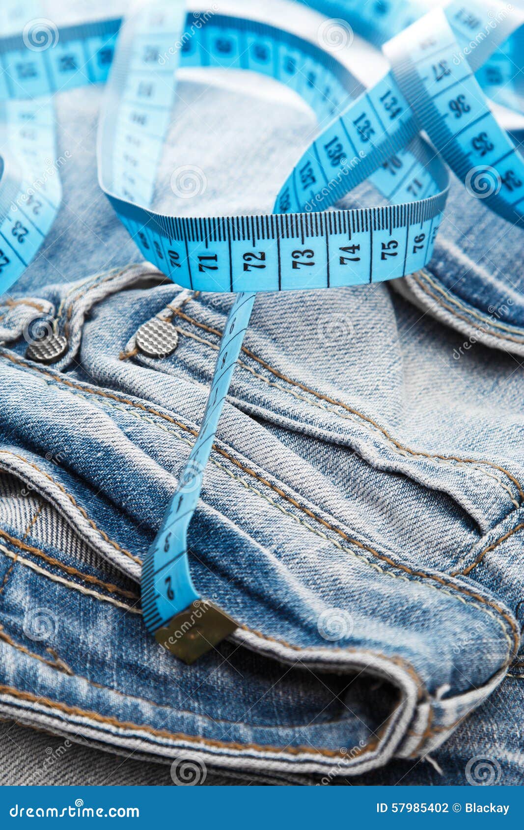 Jeans and a measuring tape stock photo. Image of size 57985402
