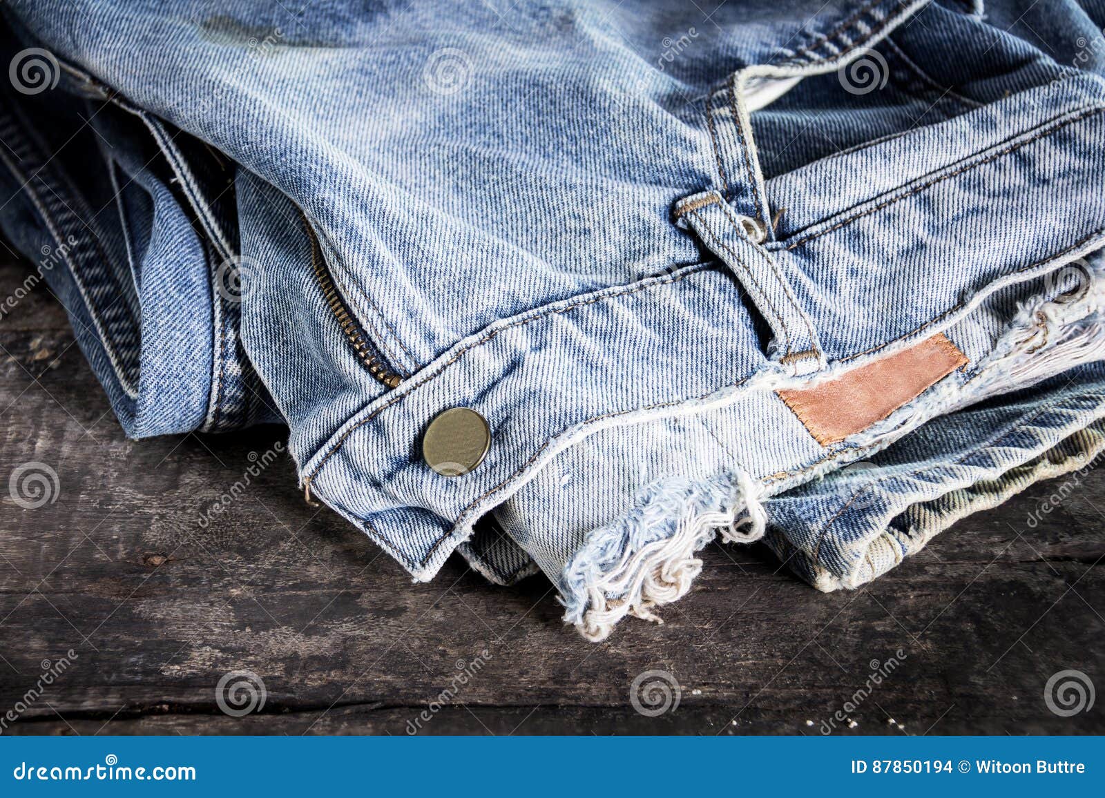 Jeans Stacked on a Wooden Background Stock Photo - Image of ...