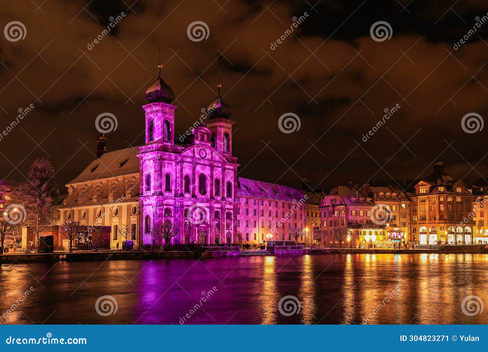 the jesuit church in swiss city lucerne is illuminated in lila color during the light show festival