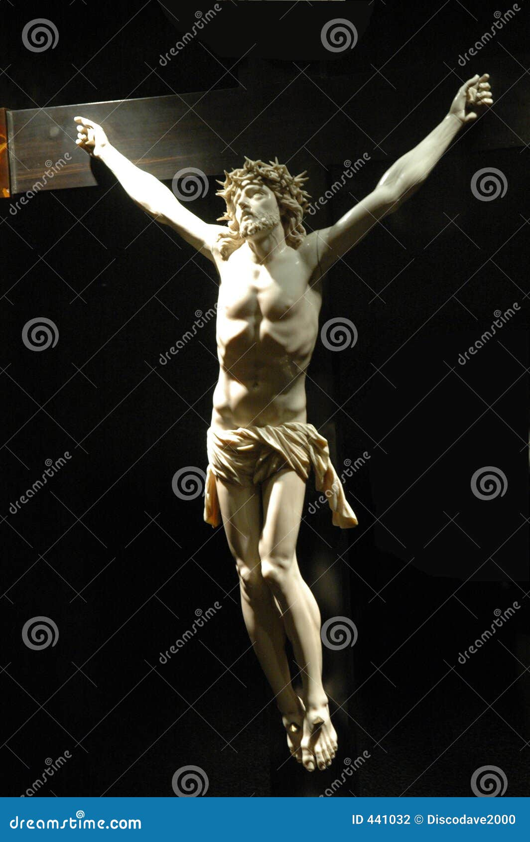 White marble sculpture of Jesus Christ on a partially visable wooden 