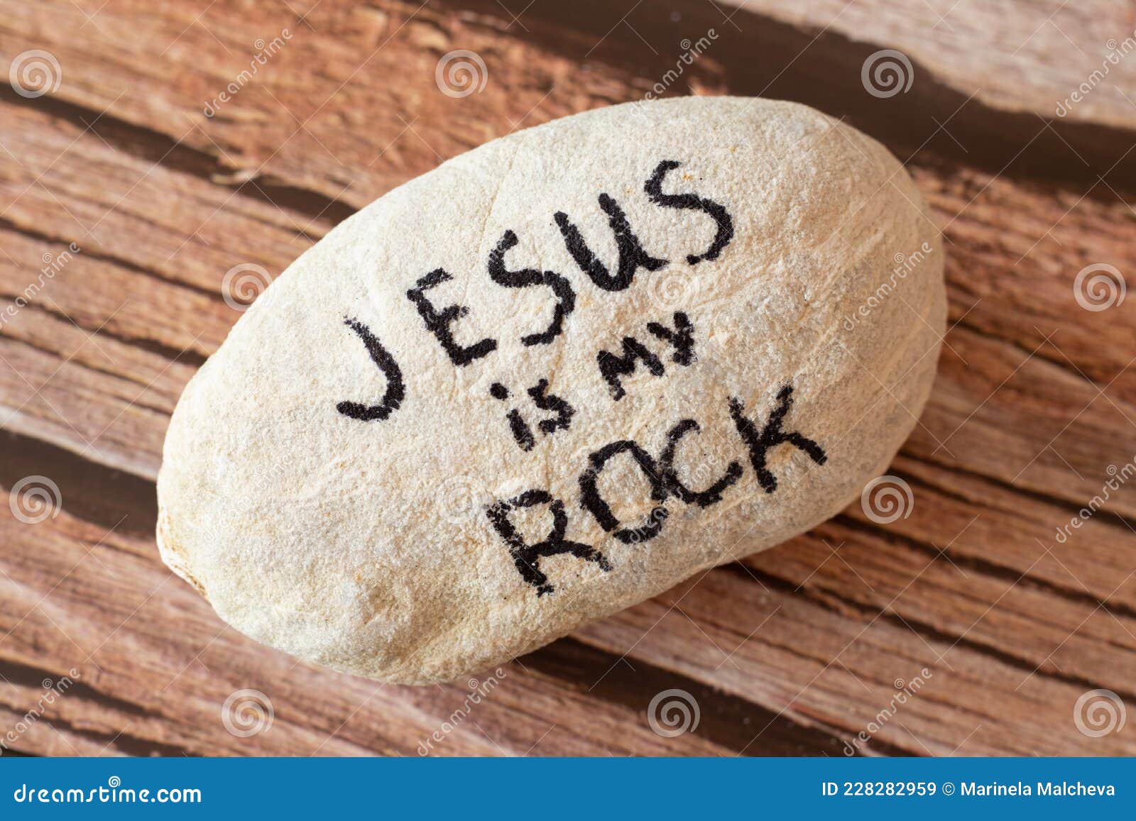 jesus christ is my god, rock, salvation, savior, and deliverer. a handwritten quote from holy bible on a stone.