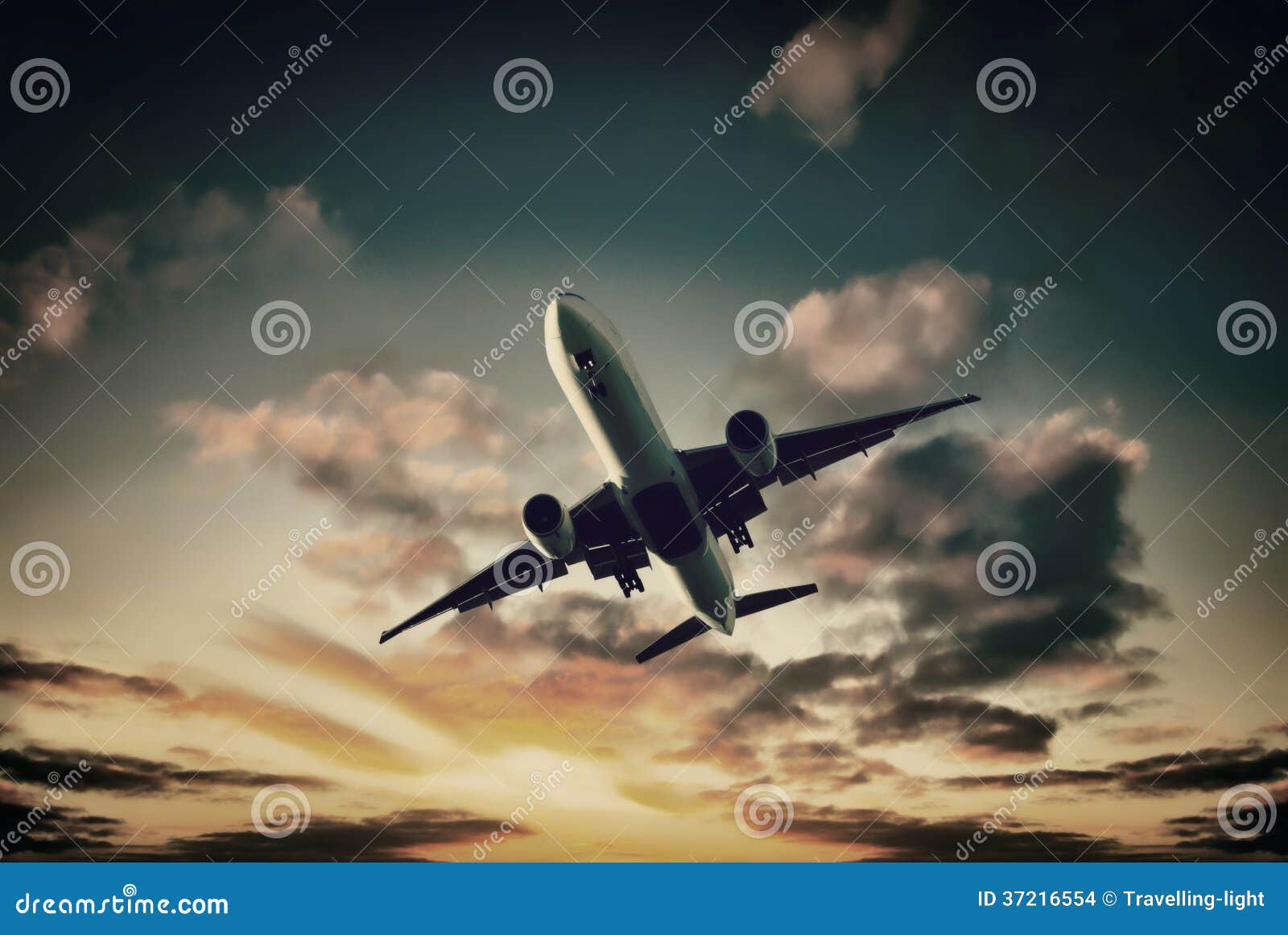 jet aeroplane landing from bright sunset sky
