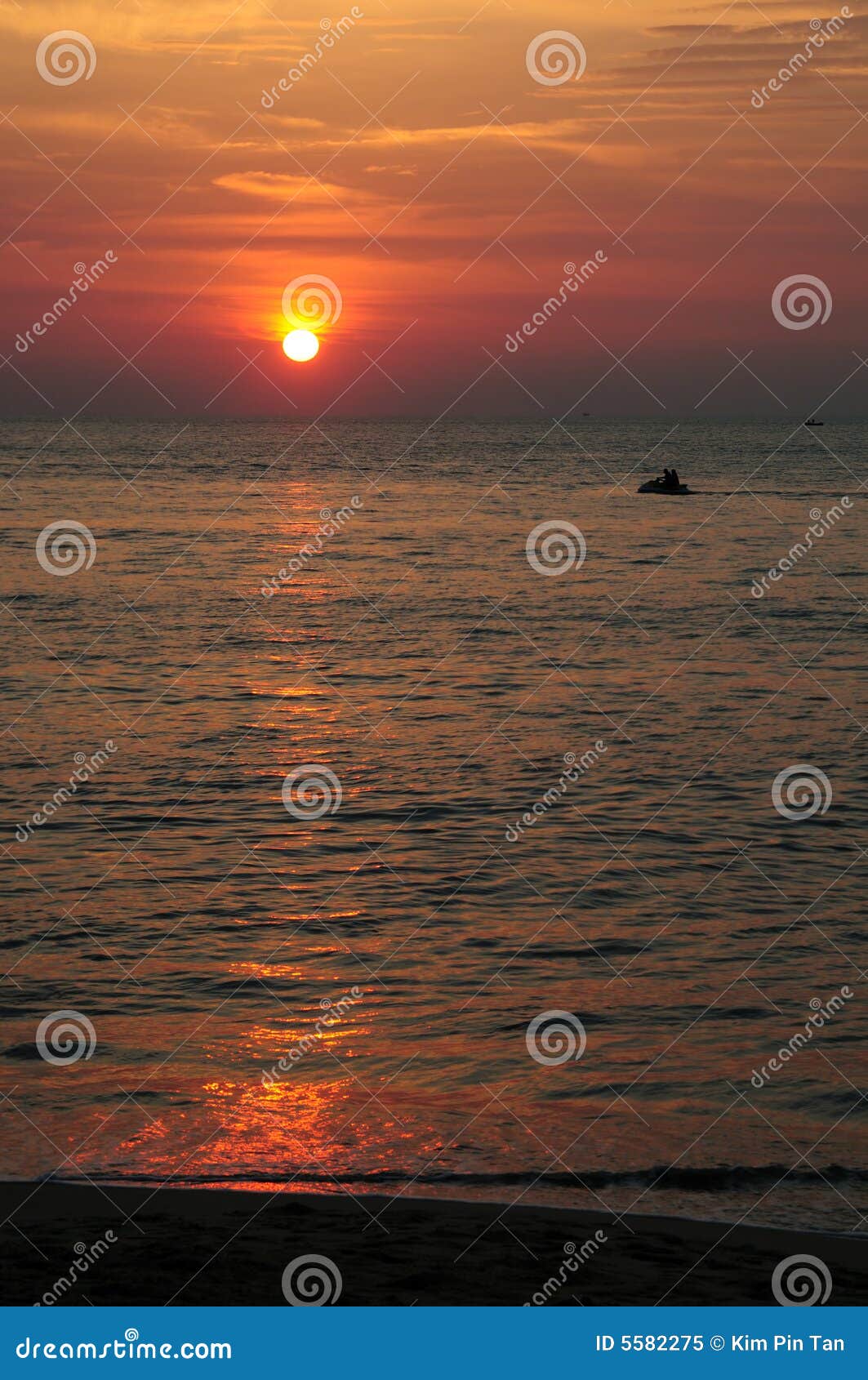 Jet skiing at sunset at tropical resort, Penang, Malaysia