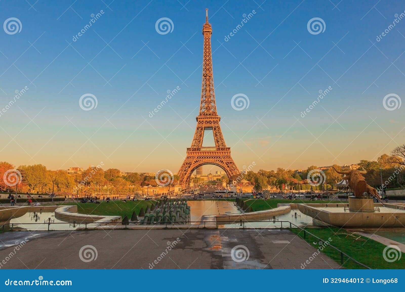 a jette across a wide open water filled park with fountains and the eiff