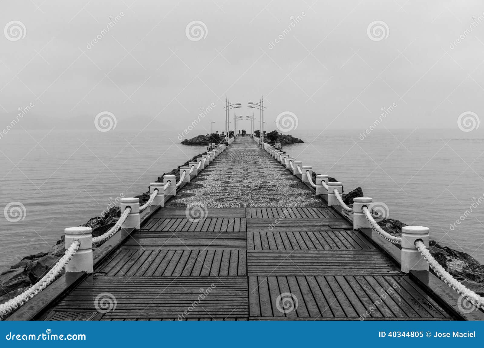 Jetty in Balneario Camboriu. A black and white picture of a jetty on a cloudy day in the touristic city of Balneario Camboriu, Brazil.